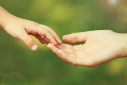 Mother's Hand Lead Her Child Daughter Outdoors On Green Defocused Background, Trust Family Concept